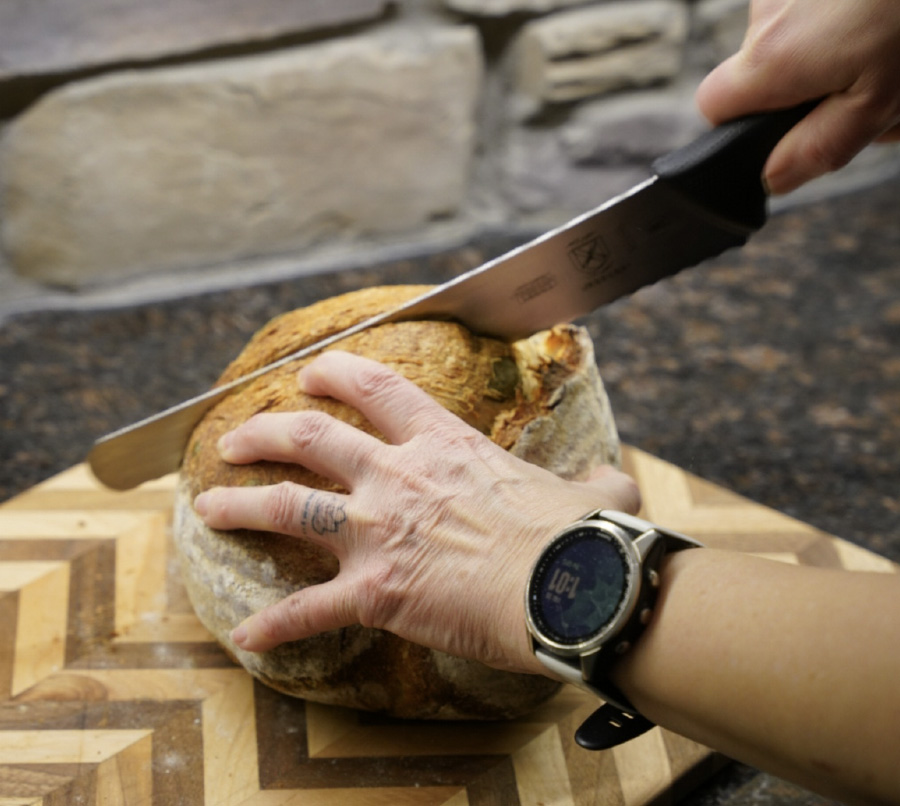 Cutting a loaf of sourdough bread